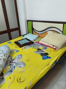 a bed with a colorful bedspread on it at villa danisa hoa in Khu Chi Lăng