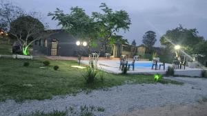 a backyard with a swimming pool at night at Espaço Vip in Brasília