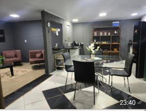a room with a glass table and chairs in it at Espaço Vip in Brasília
