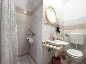 a bathroom with a toilet and a sink and a mirror at Guest House Angela in Senj +27 photos