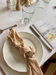 a white plate with a napkin on a table at Tørvis Hotell in Luster