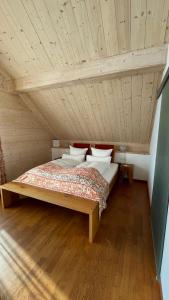a bed in a room with a wooden ceiling at Neumaier's Hotel in Biberach bei Offenburg