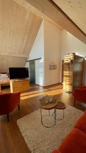 a living room with a couch and a table at Neumaier's Hotel in Biberach bei Offenburg