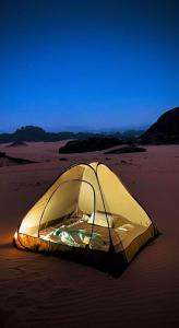 a tent laying on the sand on a beach at Leen Luxury Camp in Disah +20 photos