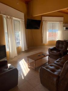 a living room with a couch and a coffee table at Apart Cerezos in Los Antiguos