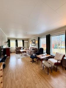 a living room with a couch and a table at Cozy House by the Lake in Vestvågøya