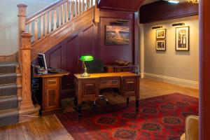 a home office with a desk and a staircase at Colwall Park - Hotel, Bar & Restaurant in Great Malvern