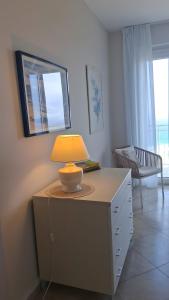 a table with a lamp on top of a dresser at Villa Bella Vista in Zambrone