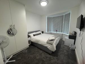 a small bedroom with a bed and a window at London Heathrow Uxbridge Escape in Uxbridge