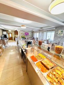 a buffet line with many different types of food at Hotel Maria del Mar in Noja
