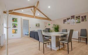 a dining room with a table and chairs at les piafs du der 1 in Joncreuil