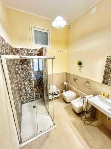 a bathroom with a shower and a toilet and a sink at a casa rà Palumma Rooms in Avola +46 photos