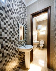 a bathroom with a sink and a toilet at Villa131 Hotel in Cairo