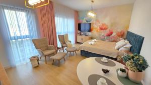 a bedroom with a bed and a living room at Boszkowo Horizon Park Apartament 14 "Laguna" in Boszkowo