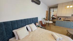 a bedroom with a large bed with two pillows on it at Boszkowo Horizon Park Apartament 14 "Laguna" in Boszkowo