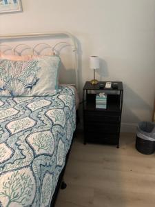 a bedroom with a bed and a night stand with a lamp at Seaside Retreat Cottages #4 in Clearwater Beach +32 photos
