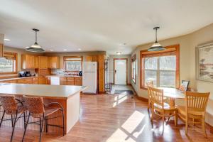 a kitchen with wooden cabinets and a table and chairs at Columbia Falls Private Retreat: Pool Table & Deck! in Columbia Falls