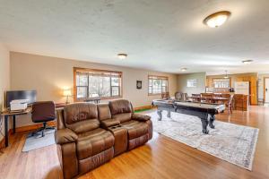 a living room with a couch and a pool table at Columbia Falls Private Retreat: Pool Table & Deck! in Columbia Falls