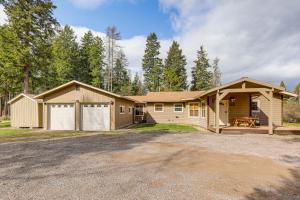 a large house with a garage and a driveway at Columbia Falls Private Retreat: Pool Table & Deck! in Columbia Falls