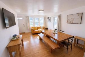 a living room with a wooden table and a couch at Spacious Home with Fire Pit & Game Room Near Yale in Hamden