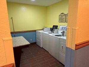 a laundry room with a washer and dryer at Days Inn by Wyndham Sault Ste Marie MI in Sault Ste. Marie +1 photo