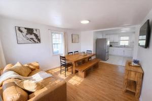 a living room with a couch and a table at Spacious Home with Fire Pit & Game Room Near Yale in Hamden +19 photos