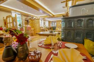a living room with a table and a largeoire at Neumaier's Hotel in Biberach bei Offenburg