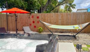 a hammock and an umbrella next to a pool at After Hours - Wilton Drive and Jacuzzi in Fort Lauderdale