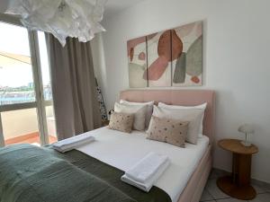 a bedroom with a bed with a large window at A & M Appartamento con garage in Livorno