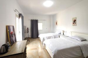 a bedroom with two beds and a window at Villa131 Hotel in Cairo