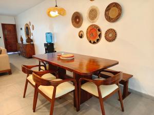 a dining room table with chairs and plates on the wall at Crystal Apartments in Malindi