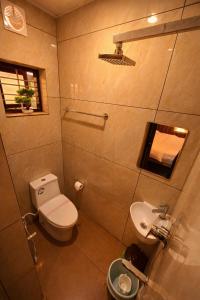 a small bathroom with a toilet and a sink at The VARKALA HAVEN 105 in Varkala