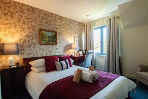 a bedroom with a bed with a teddy bear on it at Suardal Guest House in Fort Augustus