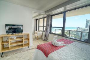 a bedroom with a bed and a large window at Oceanview Apartment on the beach 123 in Miami Beach