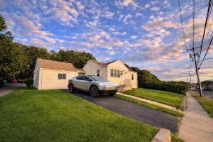 a car parked in the driveway of a house at Spacious Home with Fire Pit & Game Room Near Yale in Hamden