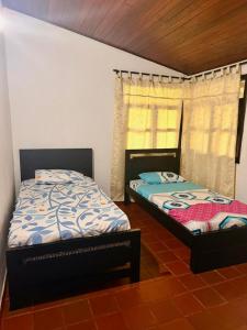 two beds sitting next to each other in a room at Finca en La Cumbre in La Cumbre