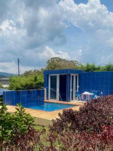 a blue house with a pool in front of it at Finca en La Cumbre in La Cumbre