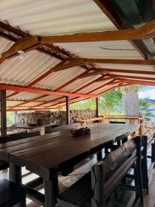 a wooden table in a pavilion with a roof at Finca en La Cumbre in La Cumbre