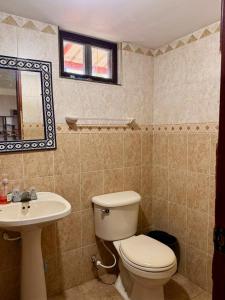 a bathroom with a toilet and a sink at Finca en La Cumbre in La Cumbre +11 photos