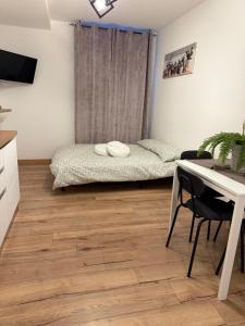 a bedroom with a bed and a desk and a table at Monica's home in Ariccia