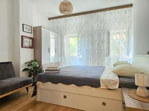 a bedroom with a large bed and a window at Sobe Biserka i Mario Brseč in Brseč