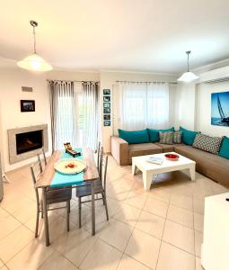 a living room with a couch and a table at SEASIDE MAISONETTE in Aroyí