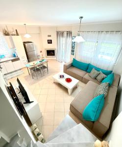 a living room with a couch and a table at SEASIDE MAISONETTE in Aroyí