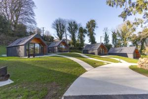 a group of small wooden buildings in a park at Narrow Water Lodges in Cornamucklagh