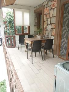 a patio with a wooden table and chairs at Jasmin Apart Otel in Göcek