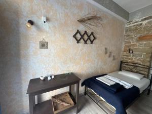 a small bedroom with a bed and a table at Anthemis home II in Agios Kirykos