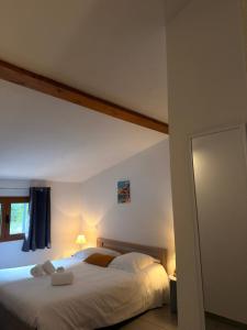 a bedroom with a large bed with white sheets at Casa Stella in Olmeto