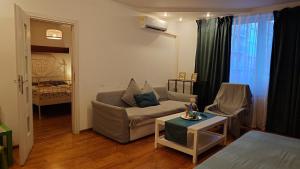 a living room with a couch and a table at Apartamenty nad Stonehenge in Dąbrowa Górnicza