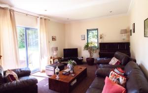 a living room with couches and a coffee table at Suardal Guest House in Fort Augustus
