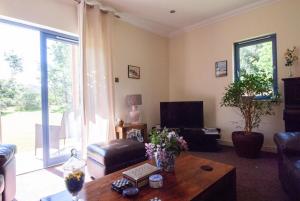 a living room with a couch and a table at Suardal Guest House in Fort Augustus +54 photos